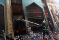 爆弾2発の爆発後に建物が炎上したイラク・バグダッド（Baghdad）市内のショルジャ（Shorjah）市場で、消火活動にあたる消防隊員ら（2014年2月13日撮影）。(c)AFP/AHMAD AL-RUBAYE