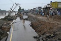 パキスタンのミルプール近郊で、地震により損壊した道路の脇に集まった人々（2019年9月25日撮影）。(c)AAMIR QURESHI / AFP