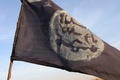 ナイジェリアのイスラム過激派組織「ボコ・ハラム」からチャド軍が奪還したナイジェリアの町ガンボルのボコ・ハラムの戦闘司令部があった場所にはためくボコ・ハラムの旗（2015年2月4日撮影）。(c)AFP/STEPHANE YAS