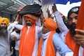 インドの首都にあるデリー国際空港で、アフガニスタンから退避してきたシーク教徒が持ち帰った同教の聖典「グル・グラント・サーヒブ」を運ぶ男性（2021年8月24日撮影）。(c)Money SHARMA / AFP