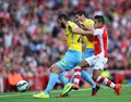 14-15イングランド・プレミアリーグ第1節、アーセナル（Arsenal）対クリスタルパレス（Crystal Palace）。クリスタルパレスの選手とボールを競るアーセナルのアレクシス・サンチェス（Alexis Sanchez、2014年8月16日撮影）。(c)AFP/CARL COURT