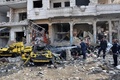 シリア中部ホムスで、2台の自動車爆弾が爆発した現場で消火活動に当たる消防隊員（2016年2月21日撮影）。(c)AFP
