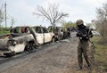 ウクライナ東部スラビャンスク（Slavyansk）近郊の検問所で起きた銃撃戦の現場を警備する武装した親ロシア派の男性（2014年4月20日撮影）。(c)AFP/GENYA SAVILOV