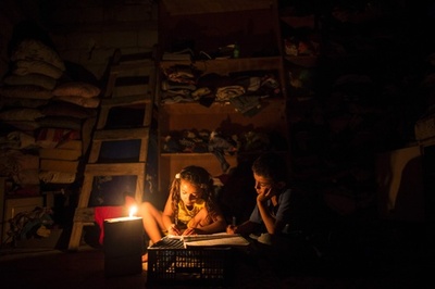 停電の中、かすかな光で学ぶ子どもたち パレスチナ・ガザ地区