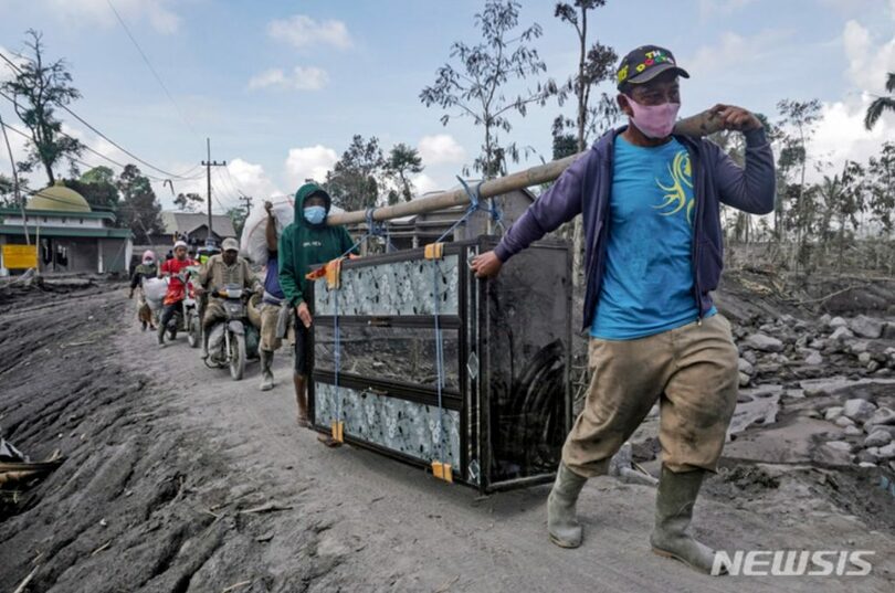 2022年12月6日、インドネシアのスメル火山の爆発を受けて避難する住民ら(c)AP/NEWSIS