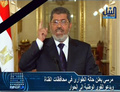エジプト・カイロ（Cairo）でテレビ演説し非常事態宣言を発令するムハンマド・モルシ（Mohamed Morsi）大統領。ナイルテレビ（NILE TV）が放送した映像より（2013年1月27日撮影）。(c)AFP/NILE TV