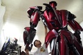 ベトナム首都ハノイの作業場で、バイクのスペアパーツから作られたロボット・ワンを整備するドー・ダイン・フォンさん（2011年9月30日撮影）。(c)Nhac NGUYEN / AFP