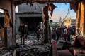 パレスチナ自治区ガザ地区ラファで、イスラエル軍の爆撃を受けた建物の状況を確かめる住民（2024年2月11日撮影）。(c)SAID KHATIB / AFP