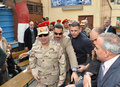 エジプト軍が公開した、首都カイロ（Cairo）の投票所を訪れたブデルファタフ・サイード・シシ（Abdel Fattah Said al-Sisi）軍最高評議会議長兼国防相（中央）の写真（2014年1月14日撮影・公開）。(c)AFP/EGYPTIAN ARMY