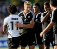 フィジーのナソーニ・ロコ（%%Nasoni Roko%%、左）と健闘を称え合うニュージーランドの選手たち。(c)AFP/Greg WOOD