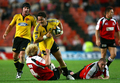 写真は、タックルに耐えて突破を図るライオンズのコブス・クロブラー（%%Cobus Grobler%%）。(c)AFP/STRINGER