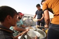 イラクのハルディヤの避難民キャンプで、食事の準備をするファルージャから逃げてきた住民たち（2016年6月20日撮影）。(c)AFP/HAIDAR MOHAMMED ALI