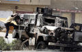 2008年4月7日、イラク・バグダッド（Baghdad）東部のシーア（Shiite）派地域サドルシティー（Sadr City）で、シーア派武装勢力とイラク・米合同部隊の戦闘で破壊された装甲車両によじ登るイラク人少年。(c)AFP/AHMAD AL-RUBAYE