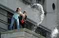 2007年12月31日、ウルグアイのモンテビデオ（Montevideo）で、ビルの窓から水をまく女性。(c)AFP/Pablo Porciuncula
