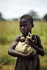 2007年10月20日、ウガンダのOlilim国内避難民キャンプで、国連世界食糧計画（World Food Program、WFP）が投下した袋を抱える子ども。(c)AFP/Roberto SCHMIDT