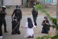 ミャンマー北部カチン州ミッチーナで、警官にデモ参加者を傷つけないよう嘆願する修道女のアン・ローズ・ヌ・タウンさん。ミッチーナ・ニュースジャーナル提供（2021年3月8日撮影、9日提供）。(c)AFP PHOTO / Myitkyina News Journal