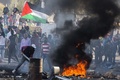 イスラエル北部クファルカナ（Kfar Kana）で、22歳の青年が警察に射殺された事件に抗議するアラブ系イスラエル人の若者たち（2014年11月9日撮影）。(c)AFP/JACK GUEZ