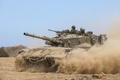 パレスチナ自治区ガザ（Gaza）地区との境界付近を移動するイスラエル軍の戦車（2014年7月25日撮影）。(c)AFP/JACK GUEZ