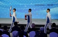 北京五輪タワーで行われた北京冬季五輪の聖火到着の歓迎式で、聖火とトーチを運ぶ関係者（2021年10月20日撮影）。(c)Noel Celis/ AFP
