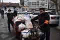 中国・武漢で、住民に食料を配達するボランティアの人々（2020年2月26日撮影）。(c)STR / AFP