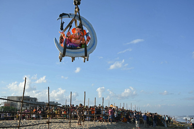 【今日の1枚】象頭の神、クレーンで海へ インド
