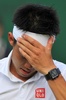 テニス、ウィンブルドン選手権（The Championships Wimbledon 2014）男子シングルス3回戦。額を押さえる錦織圭（Kei Nishikori、2014年6月28日撮影）。(c)AFP/GLYN KIRK